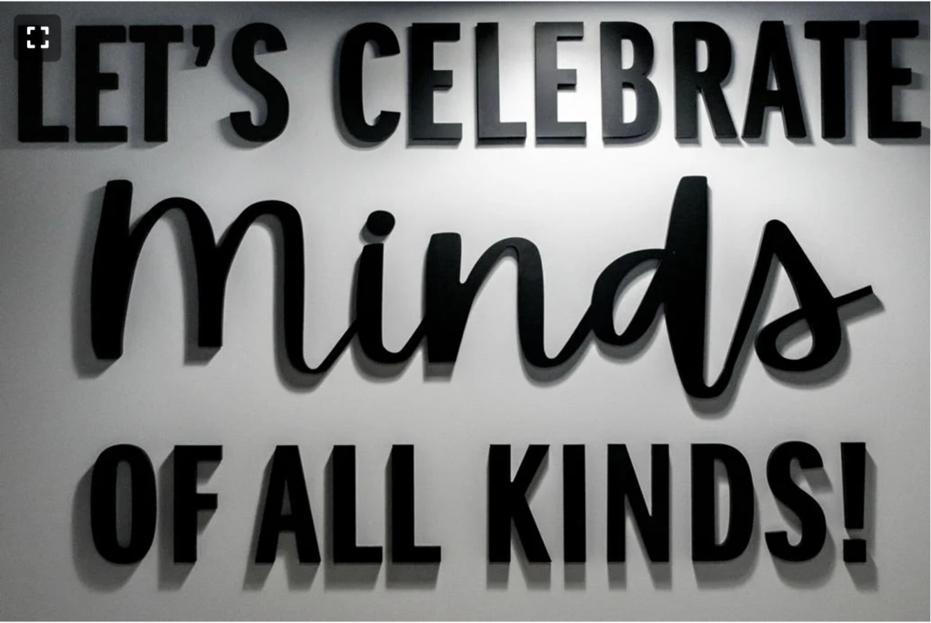 Sign says Let's Celebrate Minds of All Kinds